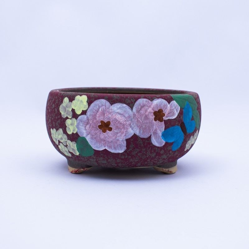 Maceta aspera con diseño de flores